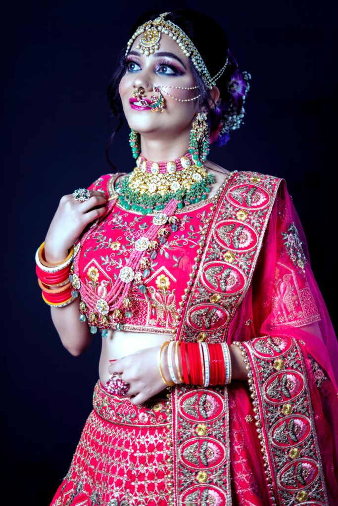 Stunning portrait of an Indian bride in traditional red wedding attire with intricate jewelry.