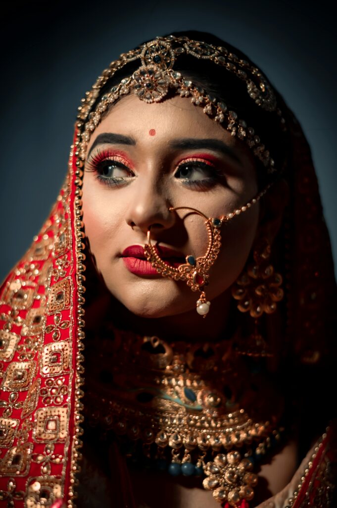 Stunning portrait of an Indian bride in vibrant traditional jewelry and attire.